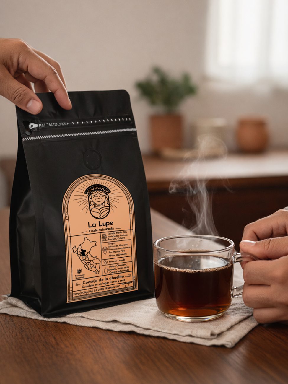 Hand holding a La Lupe coffee bag next to a cup of black coffee